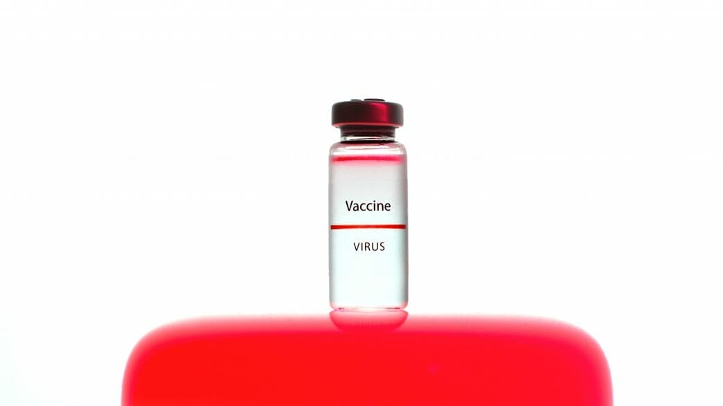 A close up view of a vaccine vial on white background