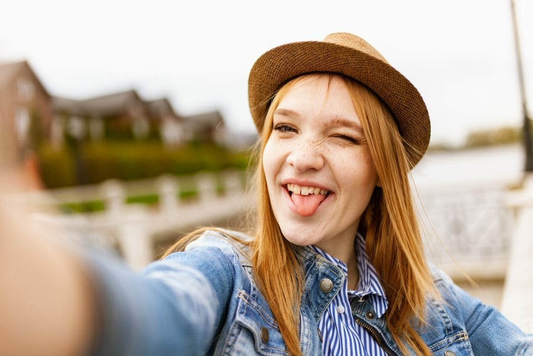 Selective focus photography of woman taking photo of herself