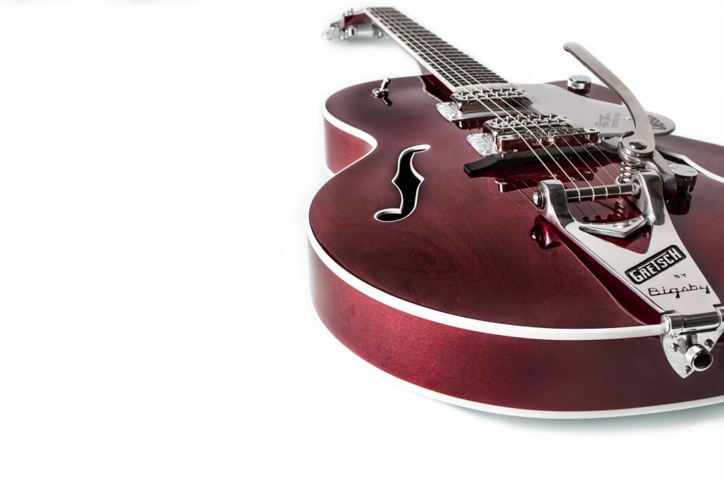 Red jazz guitar on white surface