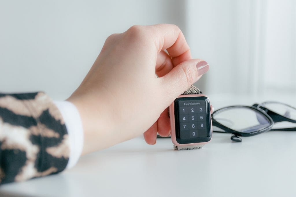 Rose gold smartwatch on white surface
